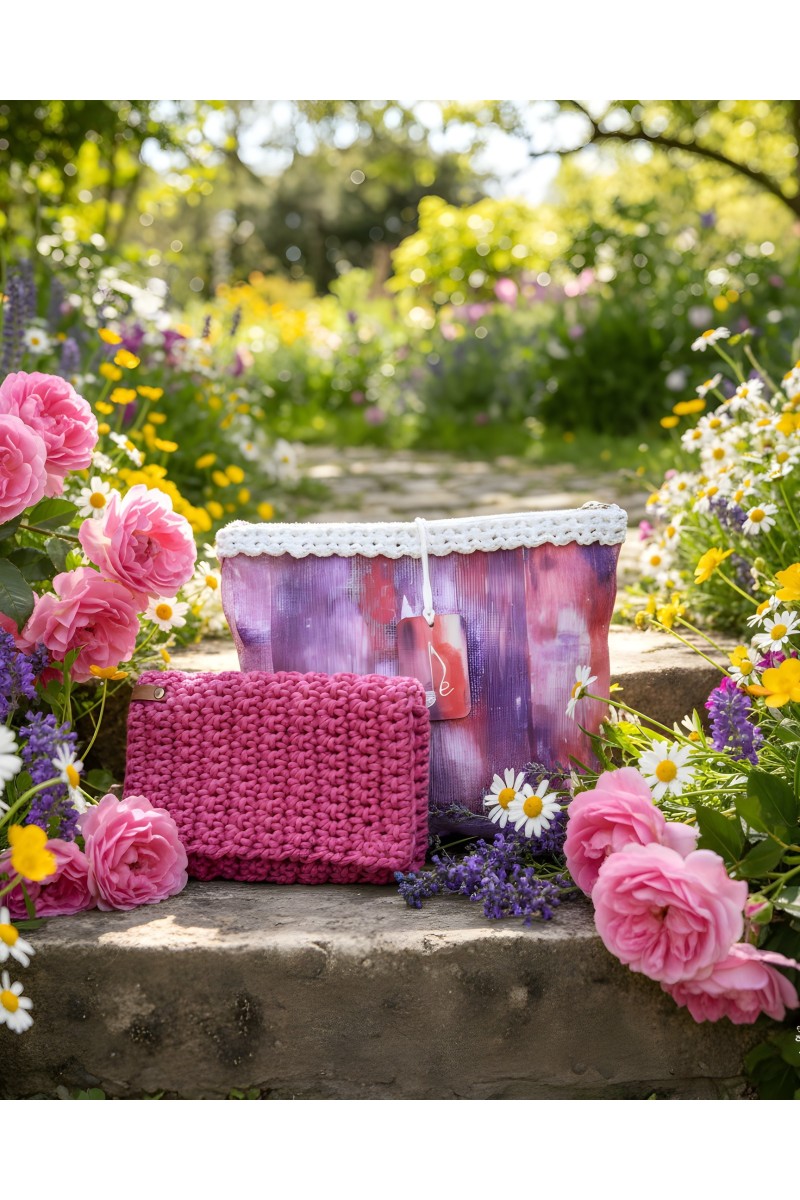 Grace Note Paionia handmade crochet wallet displayed in a blooming garden