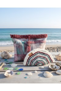 Grace Note Posidonia handmade crochet wallet displayed on a Mediterranean beach
