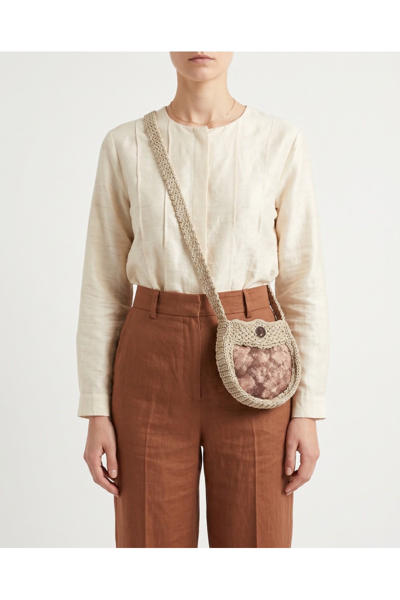 Cistus handmade crochet crossbody bag by Grace Note worn by a model.