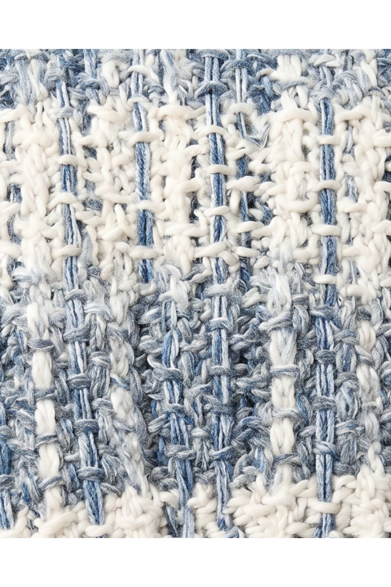 Detail of a handmade crochet scarf in white and soft blue tones