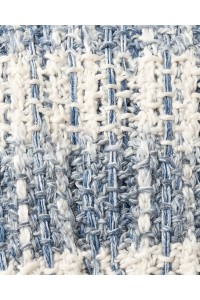 Detail of a handmade crochet scarf in white and soft blue tones