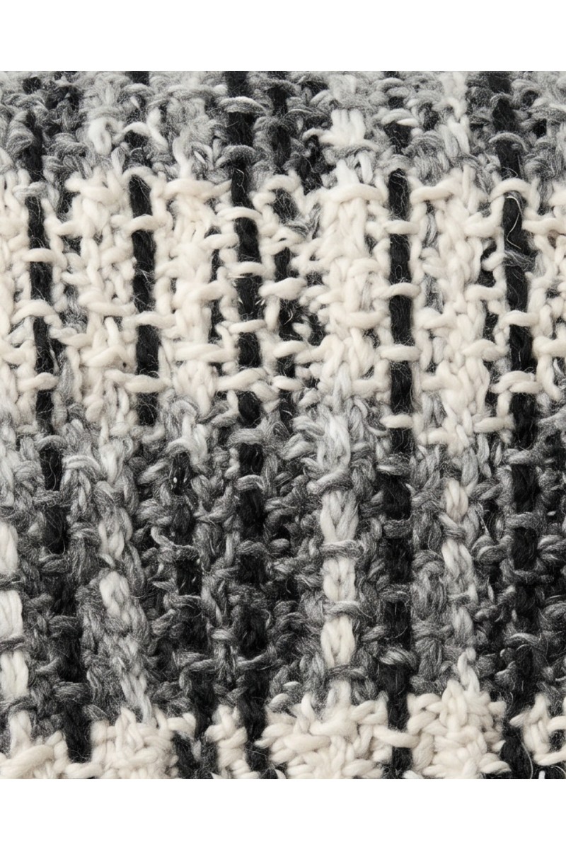 Detail of a handmade crochet scarf in grey black and white tones