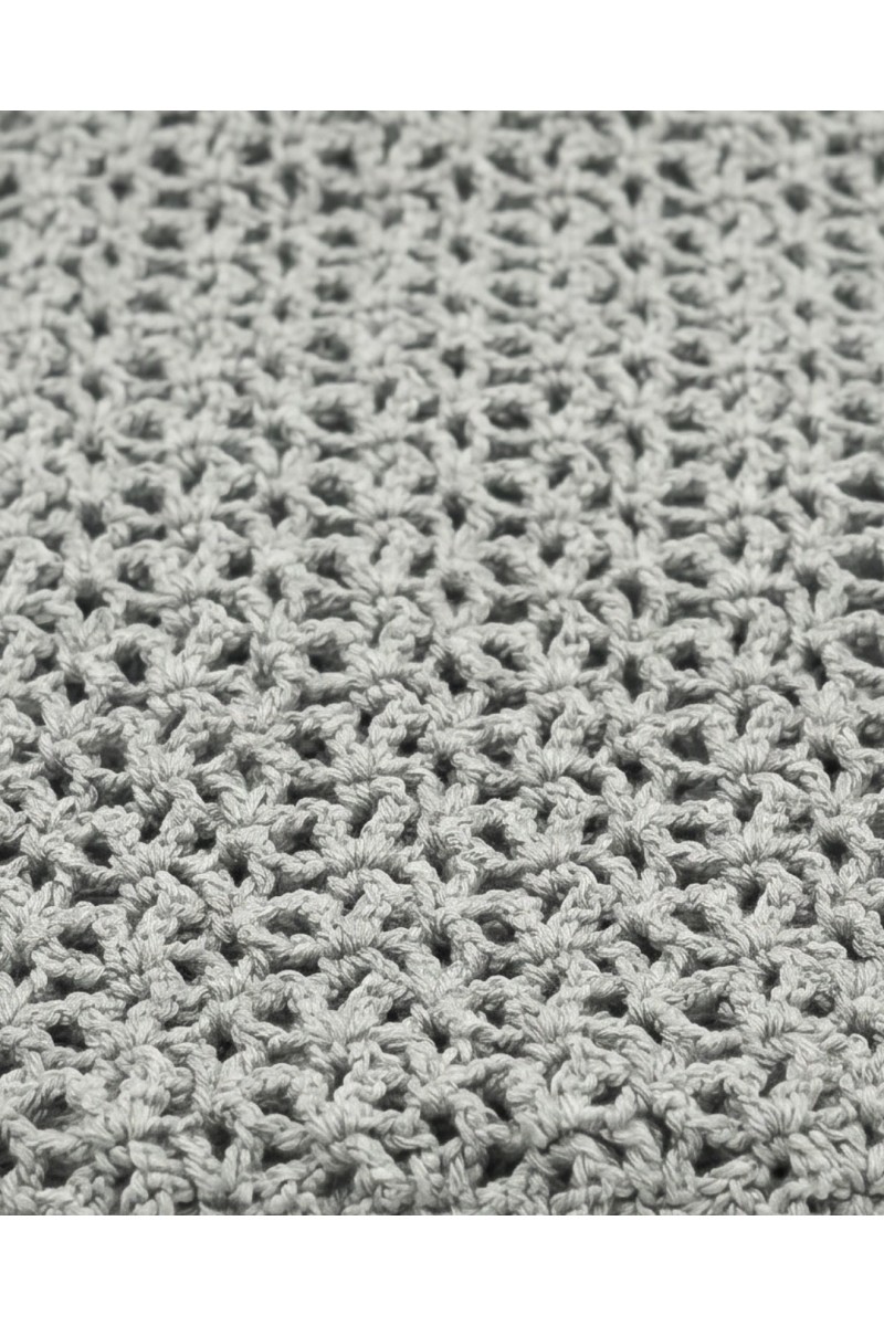 Detail of a handmade crochet scarf in light grey