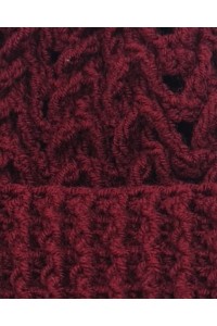 Close-up detail of textured crochet pattern on a burgundy handmade beanie