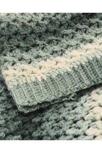 Close-up crochet texture detail of handmade sage green and cream beanie hat and cowl set