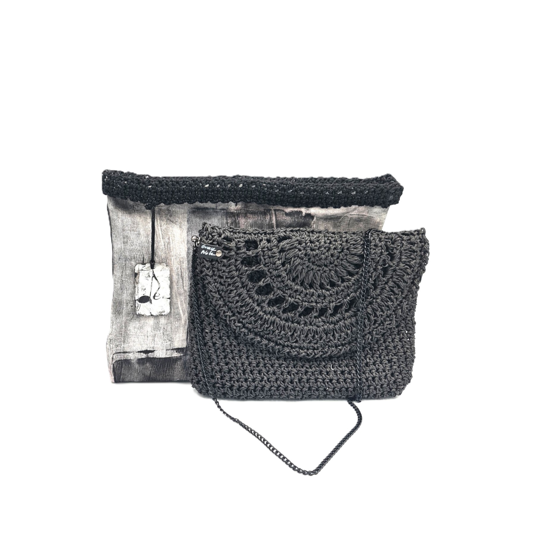 Black handmade crochet crossbody bag by Grace Note with lace flap and fabric storage pouch