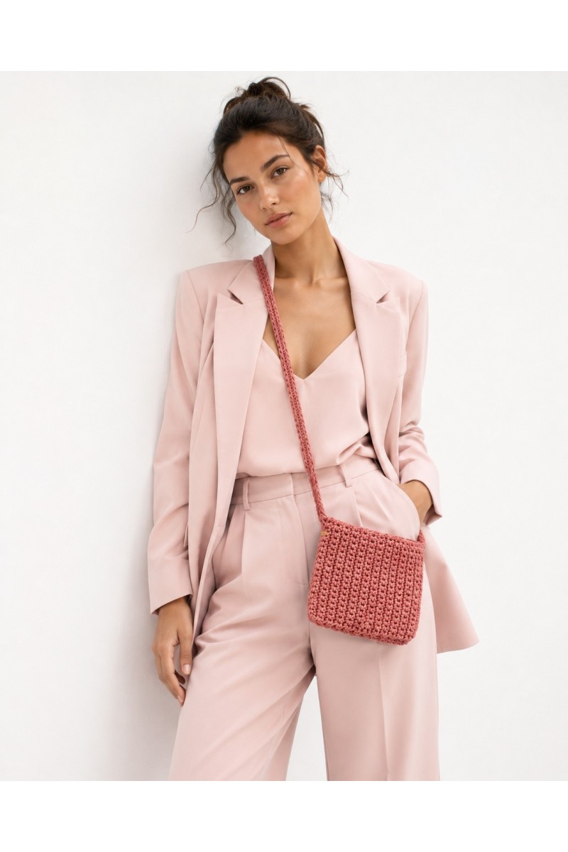 Rosetta handmade crochet crossbody bag by Grace Note styled with an elegant blush pink suit, handcrafted in Greece.